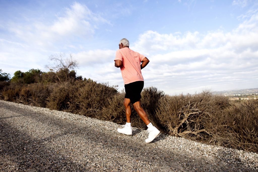 man walking up hill