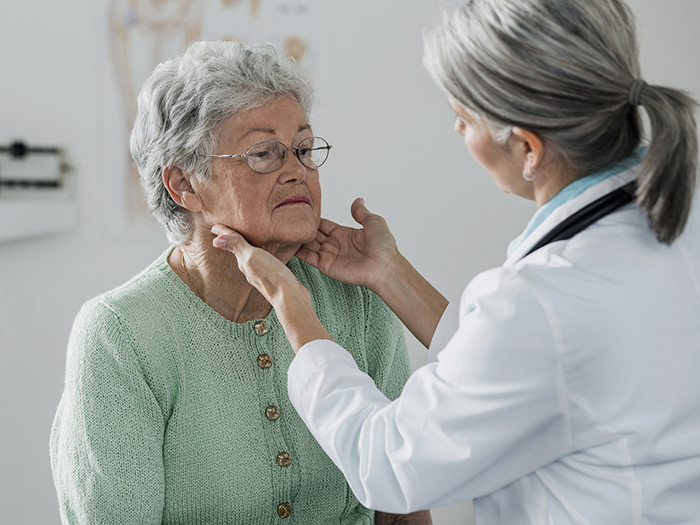doctor examining older woman