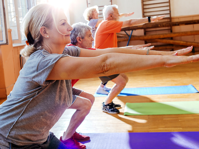 group of older adults doing squats