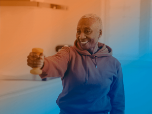 Woman holding dumbbell at home