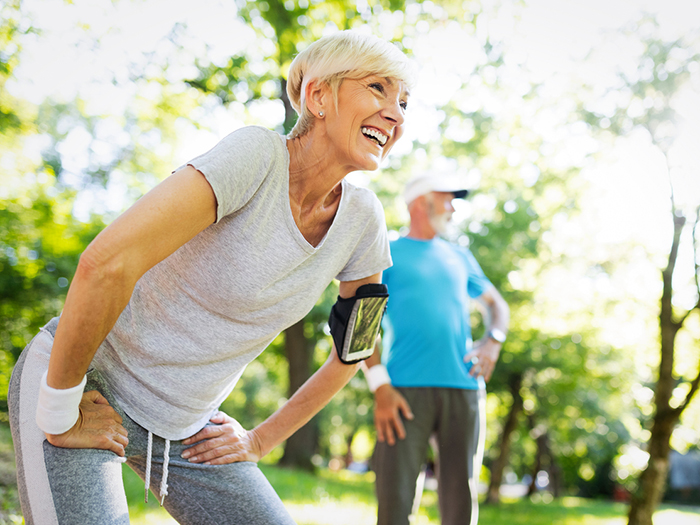 Senior couple stretching for leg exercise