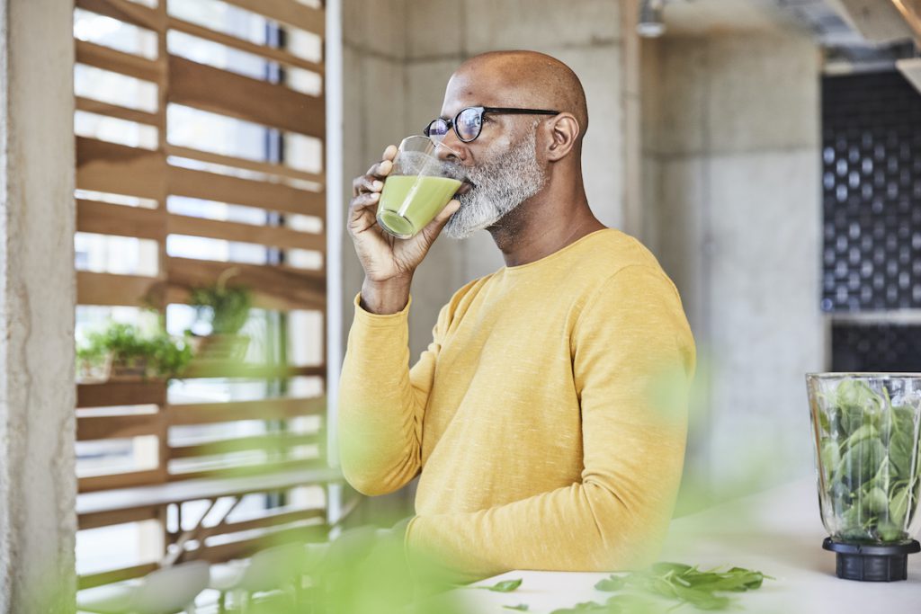 older man drinking a smoothie