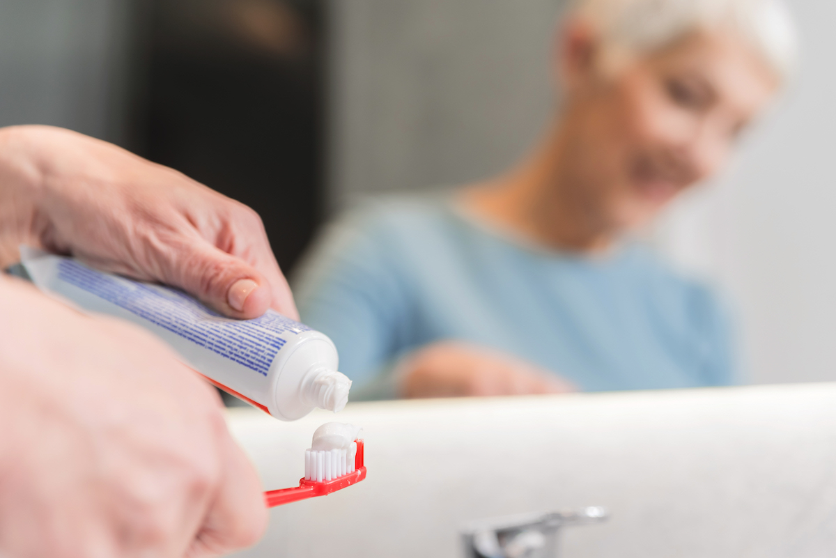 Closeup of female hands holding toothbrush