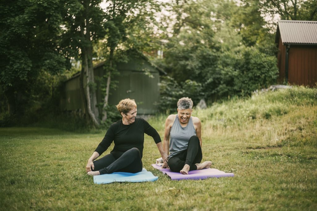 Smiling women exercising outdoors