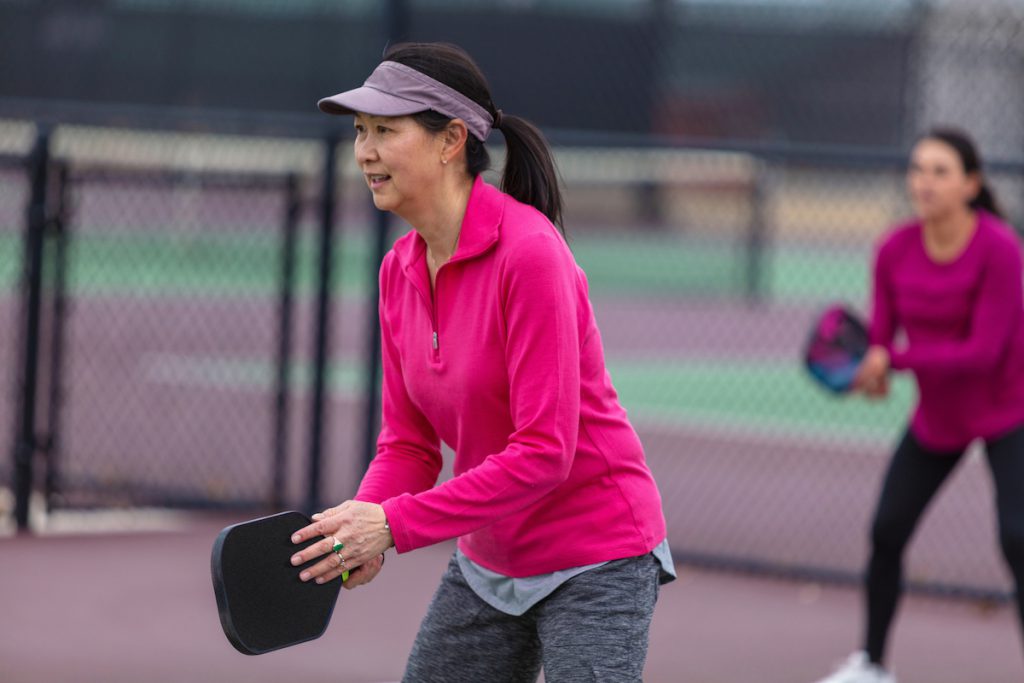 mature woman playing pickle ball