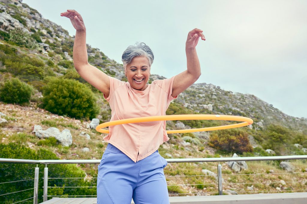 senior woman hula hooping for a story on measuring belly fat