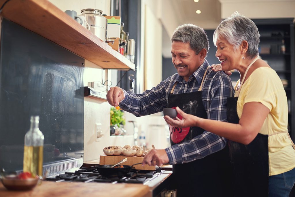 senior couple cooking dinner together for a story on the DASH diet for seniors