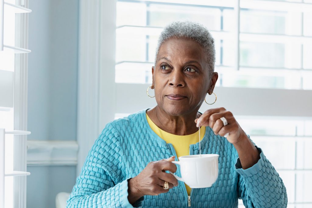 older woman drinking tea for a story on the health benefits of drinking tea