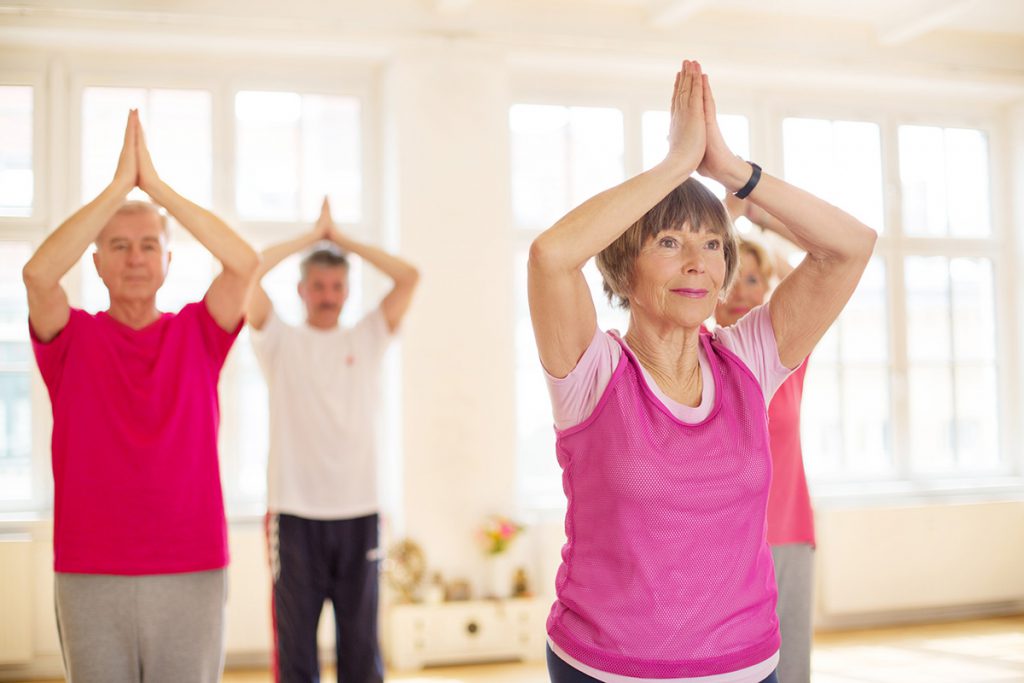 group of seniors doing yoga for a story on the brain health benefits of yoga